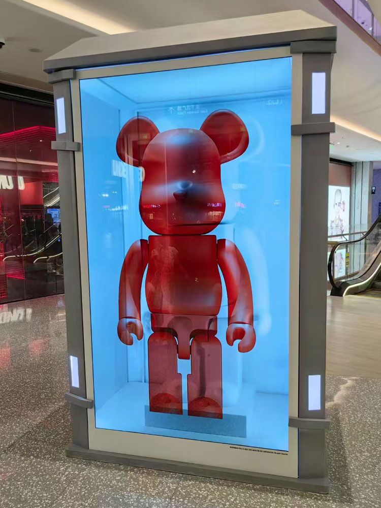 a red bear figure inside a transparent lcd display