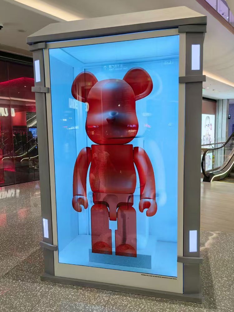 a red bear figure inside a transparent lcd display