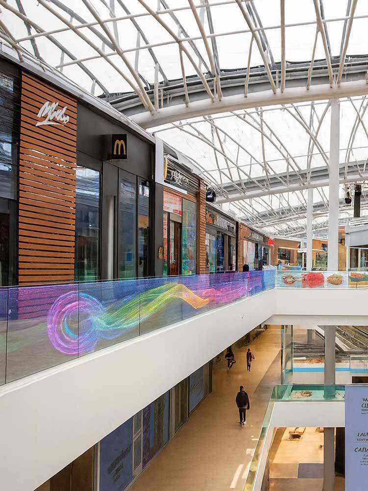 transparent led glass screen in shopping mall atrium