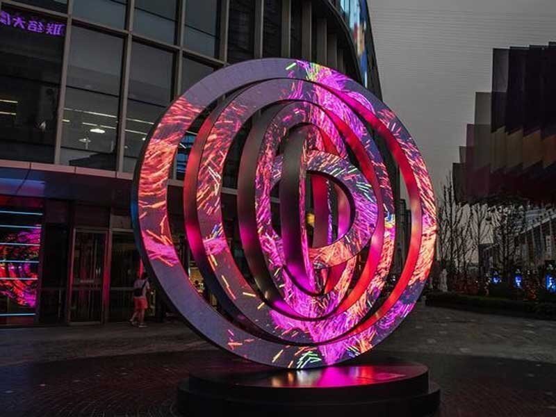 Custom-engineered 5-ring interlocking kinetic LED display sculpture, known as the Wangjing Date Eye in Beijing, featuring rotating inner rings and seamless circular LED modules.